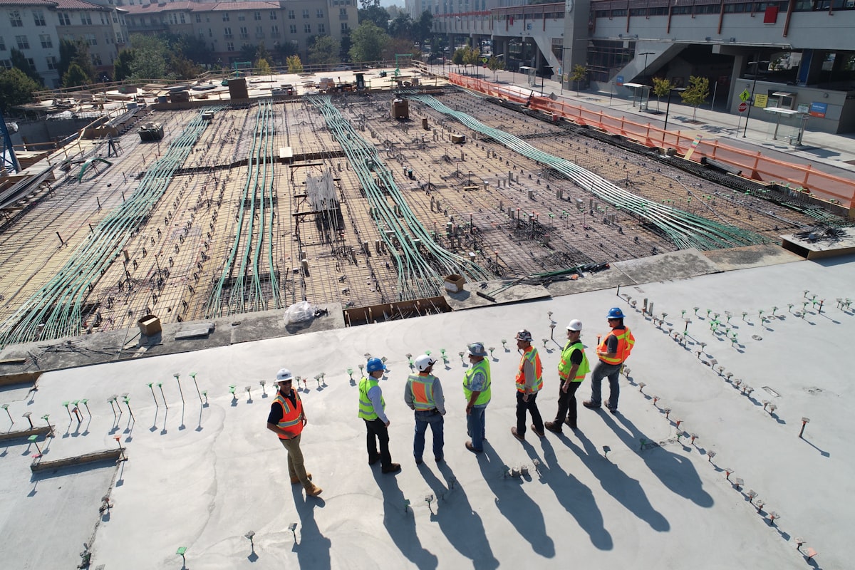 Construction workers reviewing plans on an active industrial building site